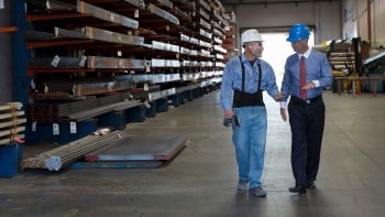 Men in lumber warehouse with hard hats