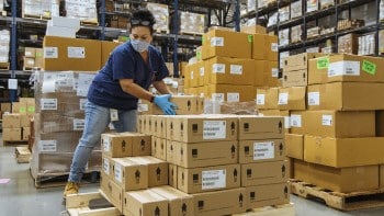 Men in warehouse reviewing clipboards