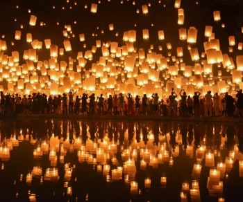 paper lanterns floating in the night sky