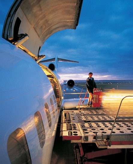 Handler loading freight on commercial air carrier