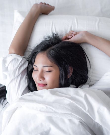 Woman waking up from a good night's sleep