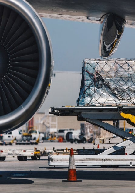 Pallet of air freight on scissor lift about to be loaded on plane