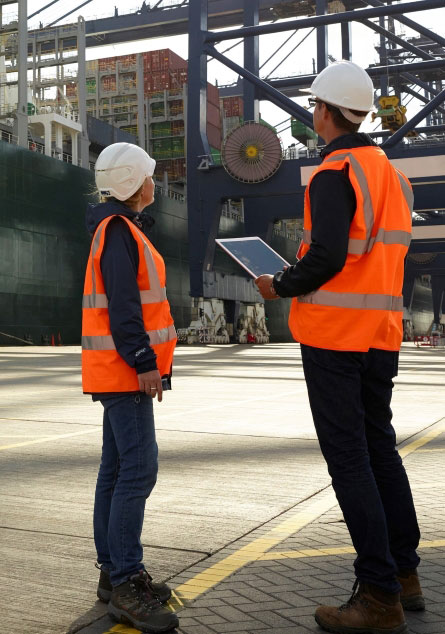 UPS worker discussing customs brokerage at port