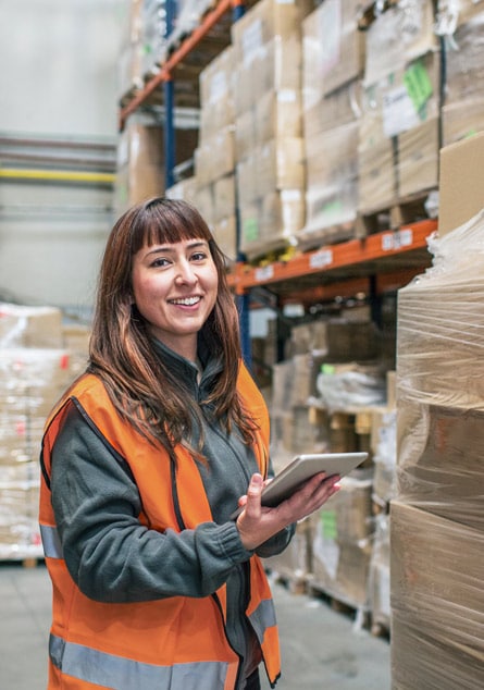 Woman in warehouse using tablet