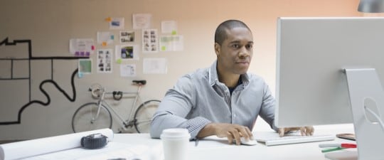 Man in office using computer