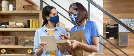 Female shop owners wearing masks