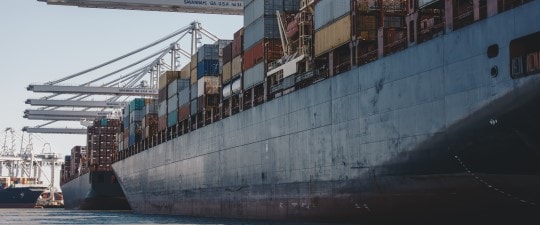 Side of freight ship loaded with shipping containers