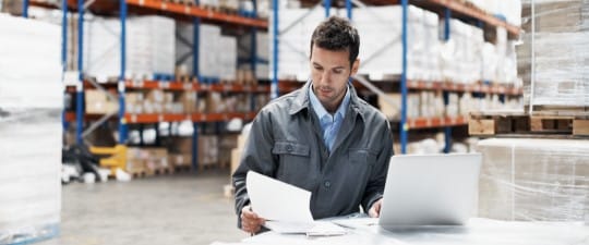 Warehouse worker using computer