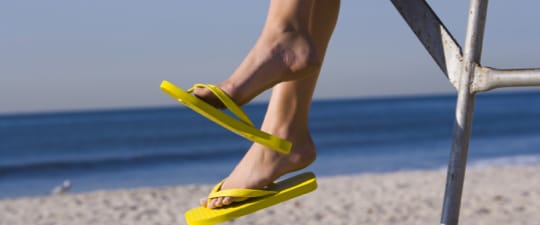 Woman in flip-flops on the beach