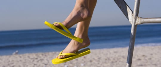 Woman in flip-flops on the beach