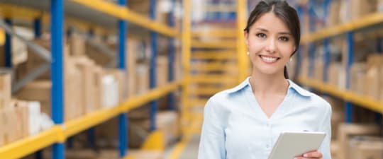 Woman in growing business UPS managing order entry using UPS integrated technology