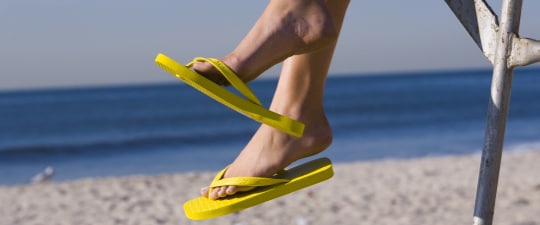 Woman in flip-flops on the beach