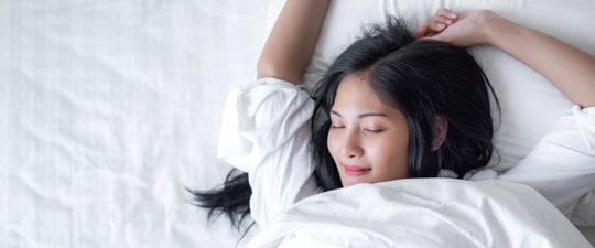 Woman waking up from a good night's sleep