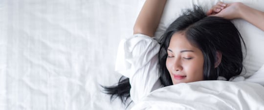 Woman waking up from a good night's sleep