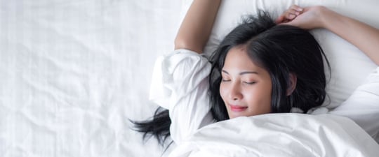 Woman waking up from a good night's sleep