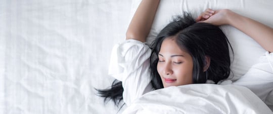 Woman waking up from a good night's sleep