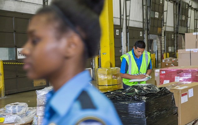 Customs agents clearing shipments in warehouse