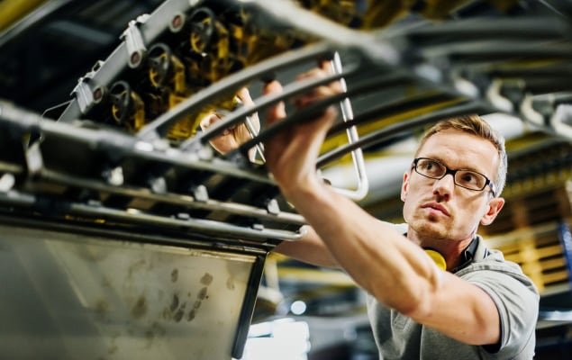 Service parts logistics field technician repairing equipment