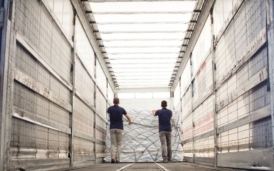 Workers unloading freight