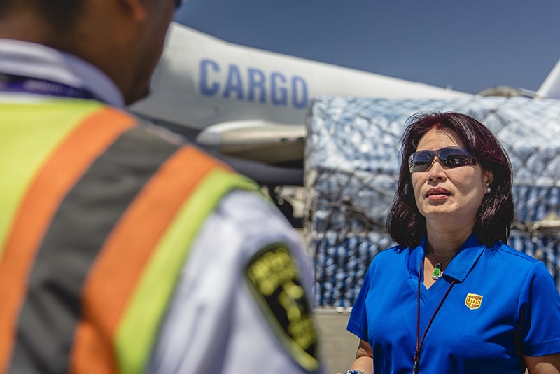 Female UPS employee speaking to customs officer