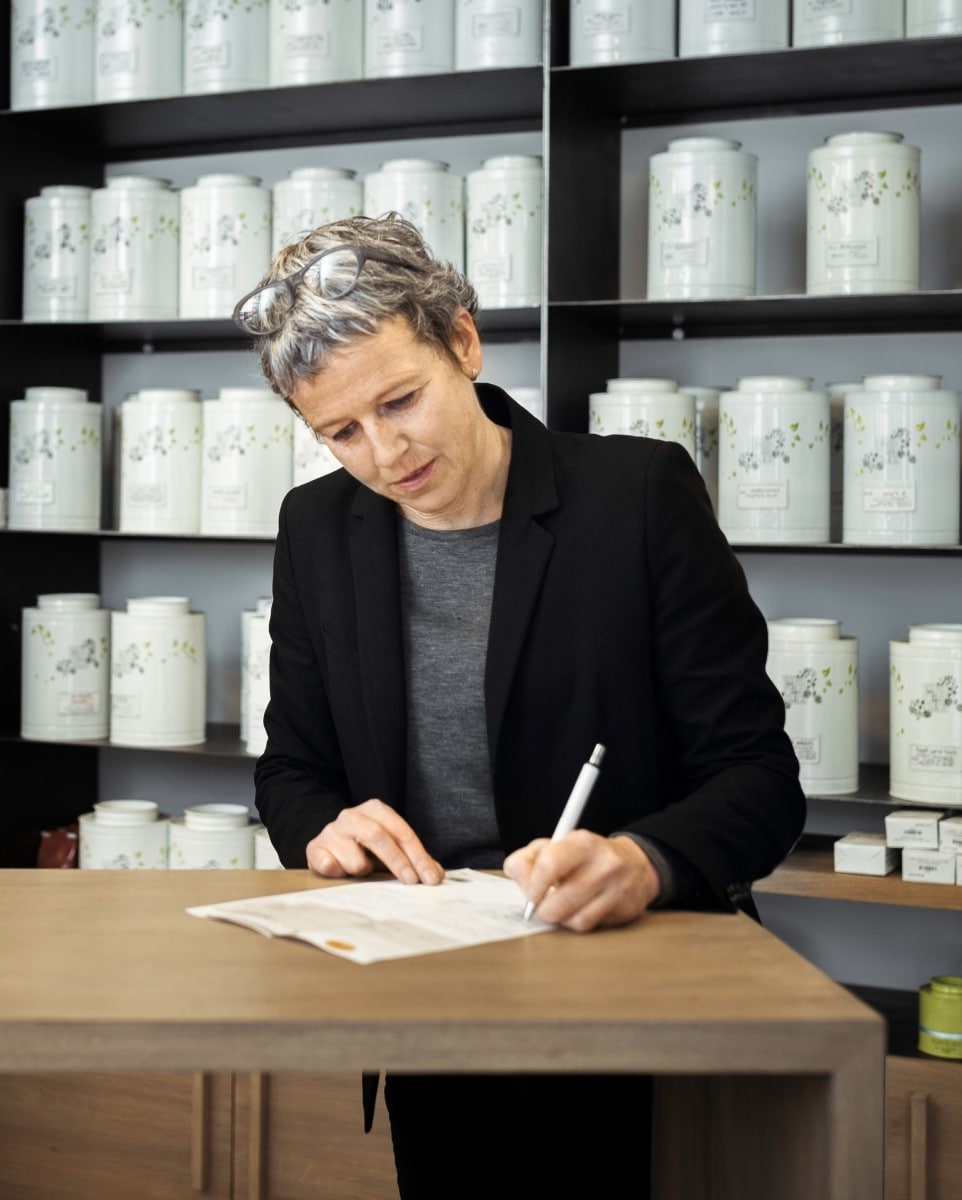 Tea shop owner taking notes on paper